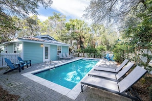 A swimming pool with lounge chairs, a small house with a porch, and surrounding trees. - Pet Friendly with Pool, Near Beach & Seaside- Moondance by Royal Destinations (Santa Rosa Beach)