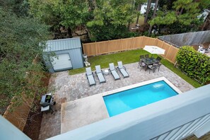A backyard with a swimming pool, a barbecue area, and a fenced garden. - Private Pool, Steps From Beach Access- Ocho Cinco by Royal Destinations (Santa Rosa Beach)