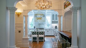 A kitchen with white cabinetry, a central island, and a chandelier. - Seaside Home w/ Rooftop Gulf Views- Off the Bucket List by Royal Destinations (Santa Rosa Beach)
