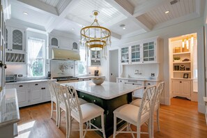 A spacious kitchen with white cabinetry, a central island, and a chandelier. - Seaside Home w/ Rooftop Gulf Views- Off the Bucket List by Royal Destinations (Santa Rosa Beach)
