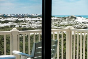 A balcony with a view of a beach and houses in the distance. - Private Pool with Gulf Lake & Park Views- SeaBatical by Royal Destinations (Santa Rosa Beach)