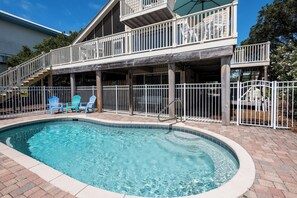 A swimming pool with a wooden deck and a covered seating area. - Private Pool with Gulf Lake & Park Views- SeaBatical by Royal Destinations (Santa Rosa Beach)