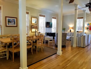 A spacious living area with a dining table, chairs, a sofa, and a television. - Pet Friendly w/ Pool Near Beach & Seaside- Tupelo Honey by Royal Destinations (Santa Rosa Beach)