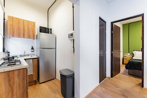 A compact kitchen with a refrigerator, microwave, and sink. - 2-Bedroom Apartment with Patio | Polanco | Relax (Ciudad de México)