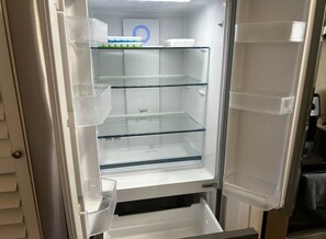 An open refrigerator with clear shelves and a 'Cool Zone' label. - Cozy 2-Bedroom Retreat in Beautiful Delray Beach (Delray Beach)