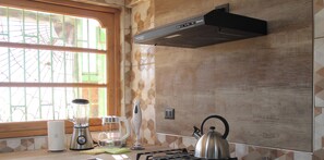 A kitchen with a window, a stove, a kettle, a blender, and a toaster. - Disegni 22 · Caldera Family Department (Caldera)