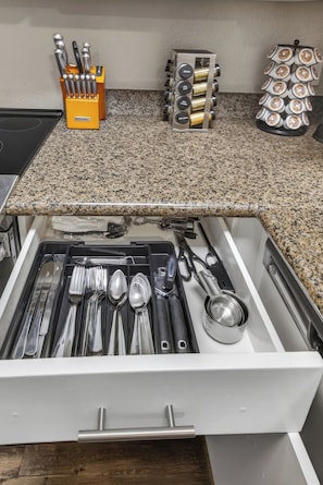 A kitchen drawer with utensils and a spice rack on the countertop. - Tranquil Escape Pool-Gym-Free Parking 1st Floor (Phoenix)