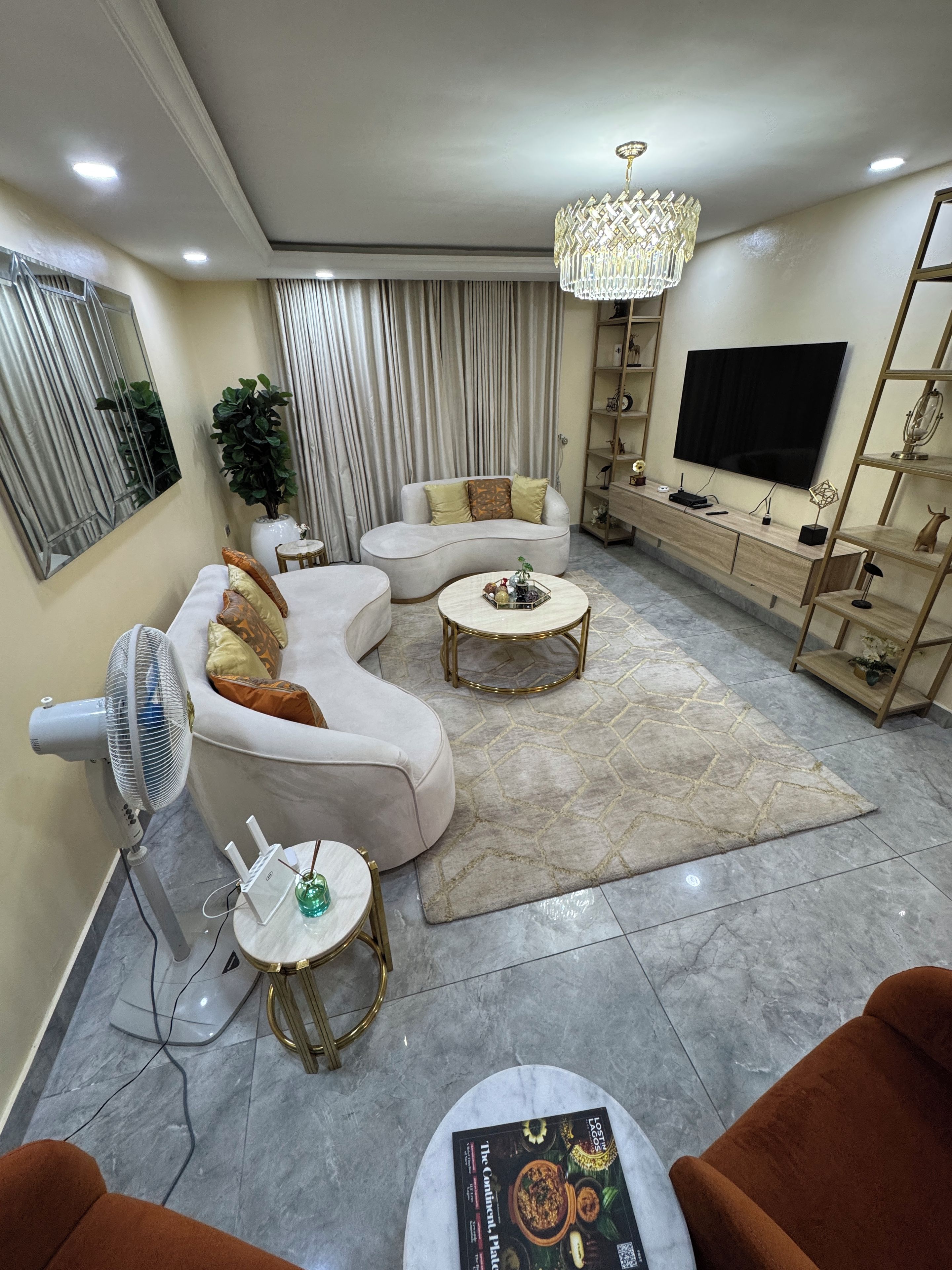 Un salon moderne avec un canapé, une table basse et un téléviseur.