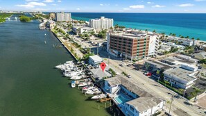 An aerial view of a coastal city with a marina, hotels, and a prominent building with a distinctive facade. - Newly Renovated, Waterfront, 2-bedroom in Hollywood! (Hollywood)