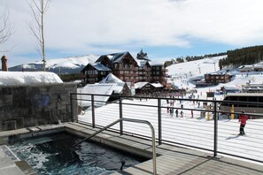 A ski resort with a pool area, wooden buildings, and a snowy landscape. - Ski-in/out suite at Grand Colorado Peak 8, pools, spa, sleeps 4 (Breckenridge)