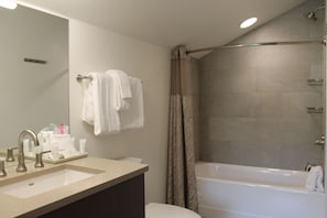 A bathroom with a sink, mirror, and bathtub. - Ski-in/out suite at Grand Colorado Peak 8, pools, spa, sleeps 4 (Breckenridge)
