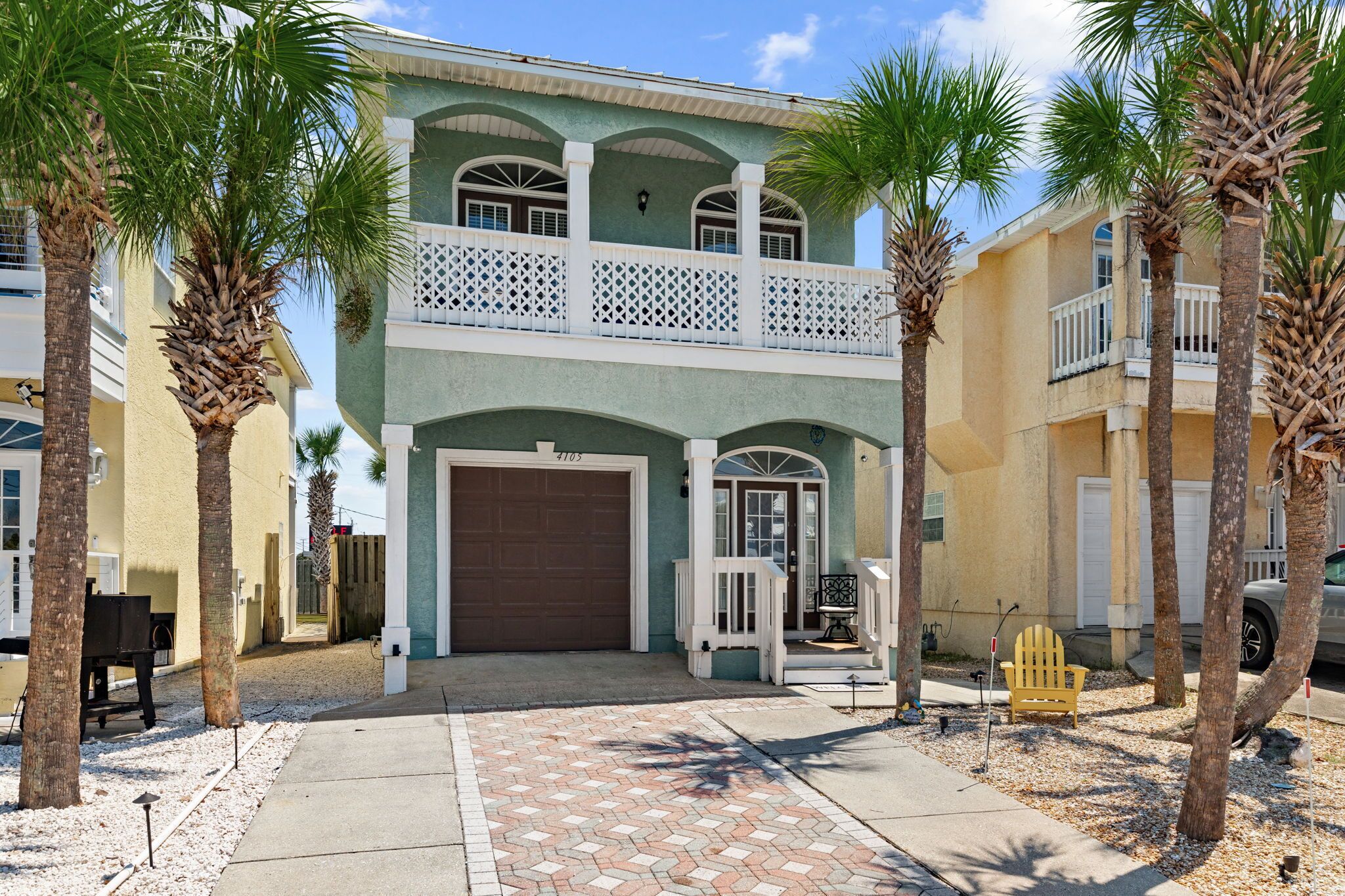 A two-story house with a garage, a balcony, and a driveway.