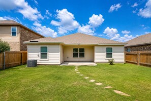 A two-story house with a front yard, a wooden fence, and a clear blue sky. - Perfect 4-bedroom house with AC in fabulous Anna Tx (Anna Tx)