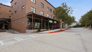 A brick building with a storefront labeled 'Prince Market' and a sign for 'Yossi.'