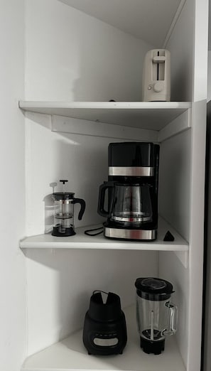 A kitchen shelf with a coffee maker, a blender, and a thermos. - The Little Sound Retreat, Room Rental Close to PSNS, Ferry & More! (Bremerton)