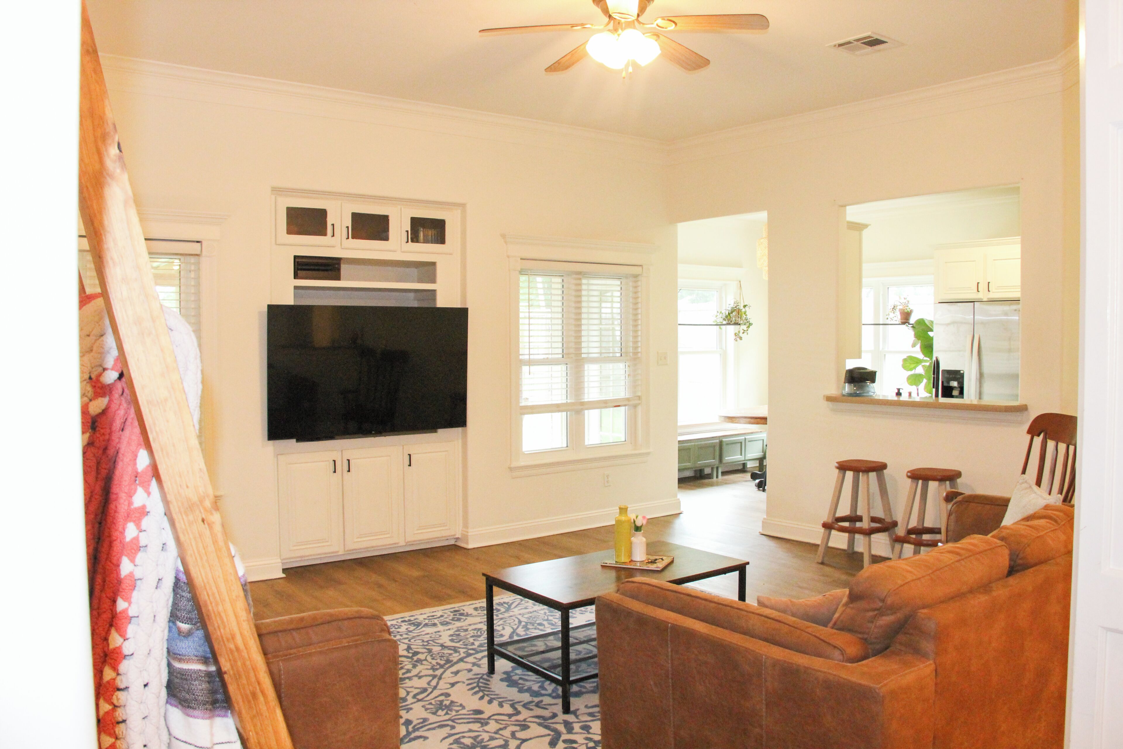 A living room with a sofa, a coffee table, and a television.