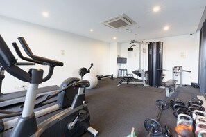 A gym with cardio equipment, weightlifting stations, and a variety of dumbbells. - Stylish Milton Pad - Sweeping River Views & Pool (Milton)