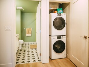 A laundry room with a washing machine and dryer, a toilet, and a patterned floor. - Free Parking - Historic 2BR Apartment DT Halifax (Halifax)