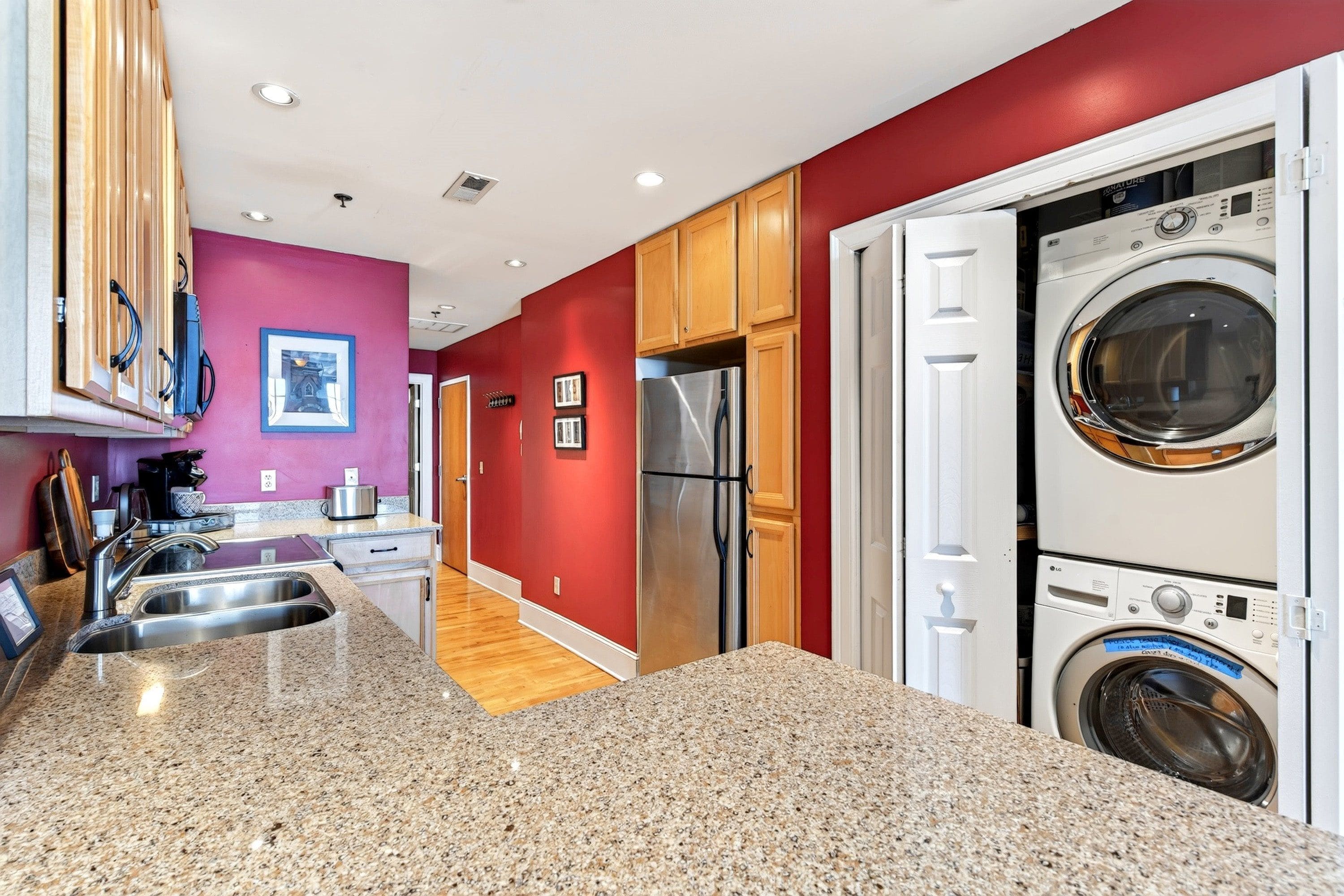 A modern kitchen with granite countertops, stainless steel appliances, and wooden cabinets.