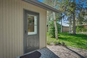 A single-story building with a front door, a small porch area, and a gravel driveway. - 7 minutes to Yellowstone The Aspen Cabin (West Yellowstone)