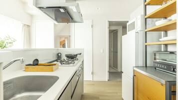 A modern kitchen with a stainless steel sink, a gas stove, and a built-in oven.