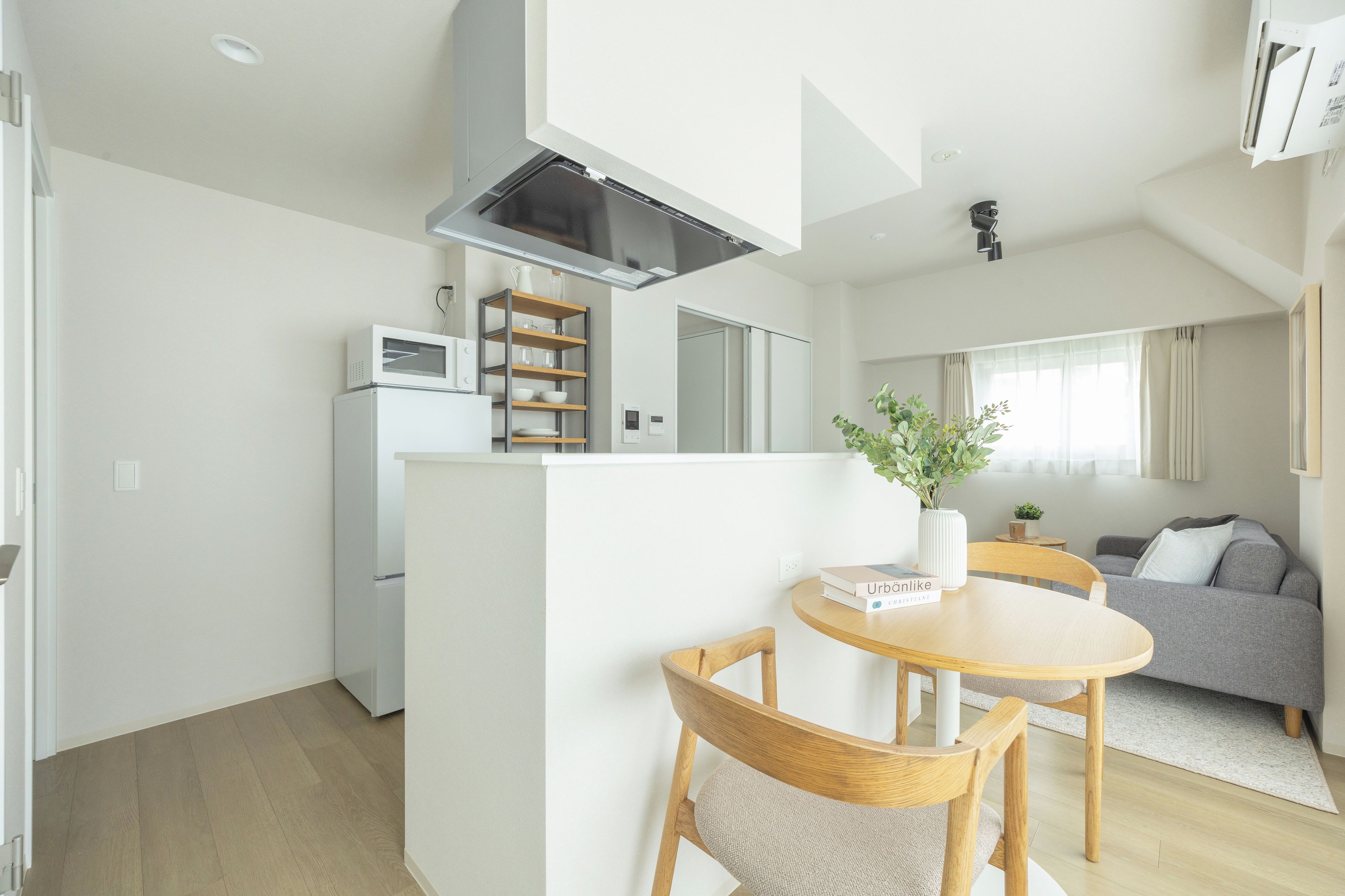 A modern apartment with a kitchen, dining area, and living room.