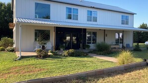A two-story house with a covered porch, large windows, and a well-maintained lawn. - 4 bed 3.5 bath on 5 acres 5 minutes to Walmart supercenter and 6 minutes to OSU. (Stillwater)