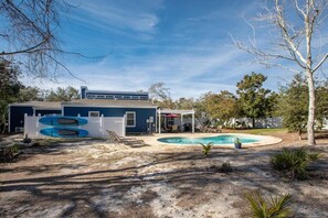 A residential property with a swimming pool, a covered patio, and a garage. - Miramar Home with Private Pool, Large Deeded Beach Access, Bikes & Paddleboards (Miramar Beach)