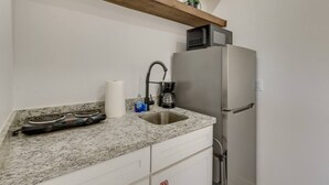 A kitchen with a stainless steel refrigerator, a microwave, a gas stove, and a sink. - #7 | Modern SPI Beach Studio + Pool | Smart TV (South Padre Island)