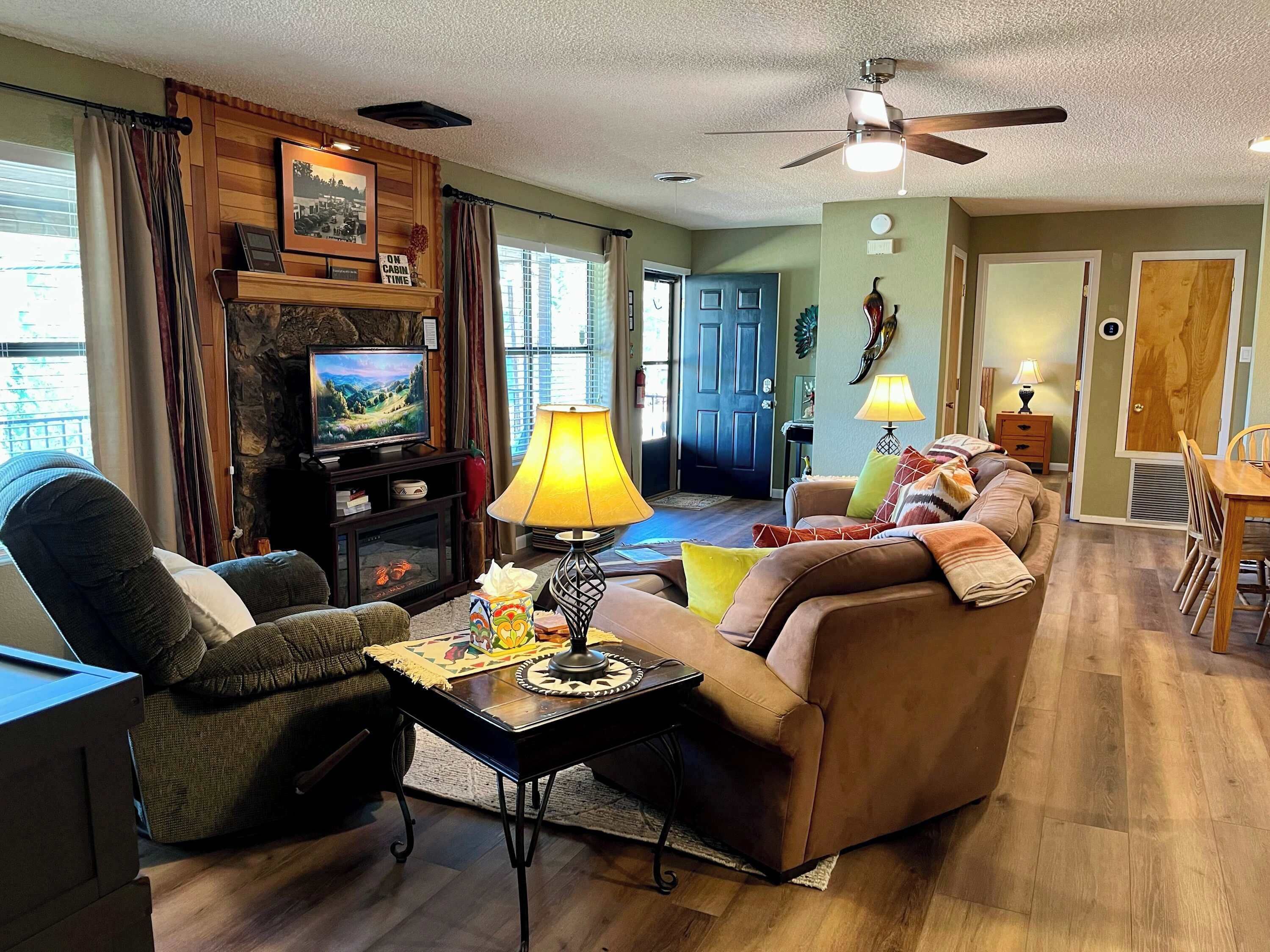 A living room with a fireplace, television, and seating area.