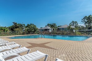 A swimming pool with lounge chairs and a paved deck. - 4005 Rookery 3 Sea Story (Gulf Shores)