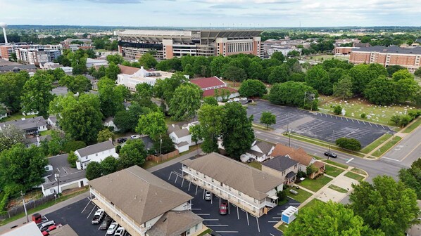 An aerial view of a campus with multiple buildings, parking areas, and green spaces.
