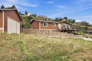A single-story house with a stone foundation and a wooden exterior. - Dixon Cove Lookout Near Horsetooth Res (Fort Collins)