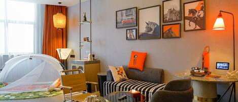 Ein modernes Wohnzimmer mit Sofa, Sesseln, Couchtisch und einer zeltartigen Struktur.