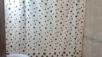 Ein Badezimmer mit Duschvorhang, Waschbecken und Toilette.