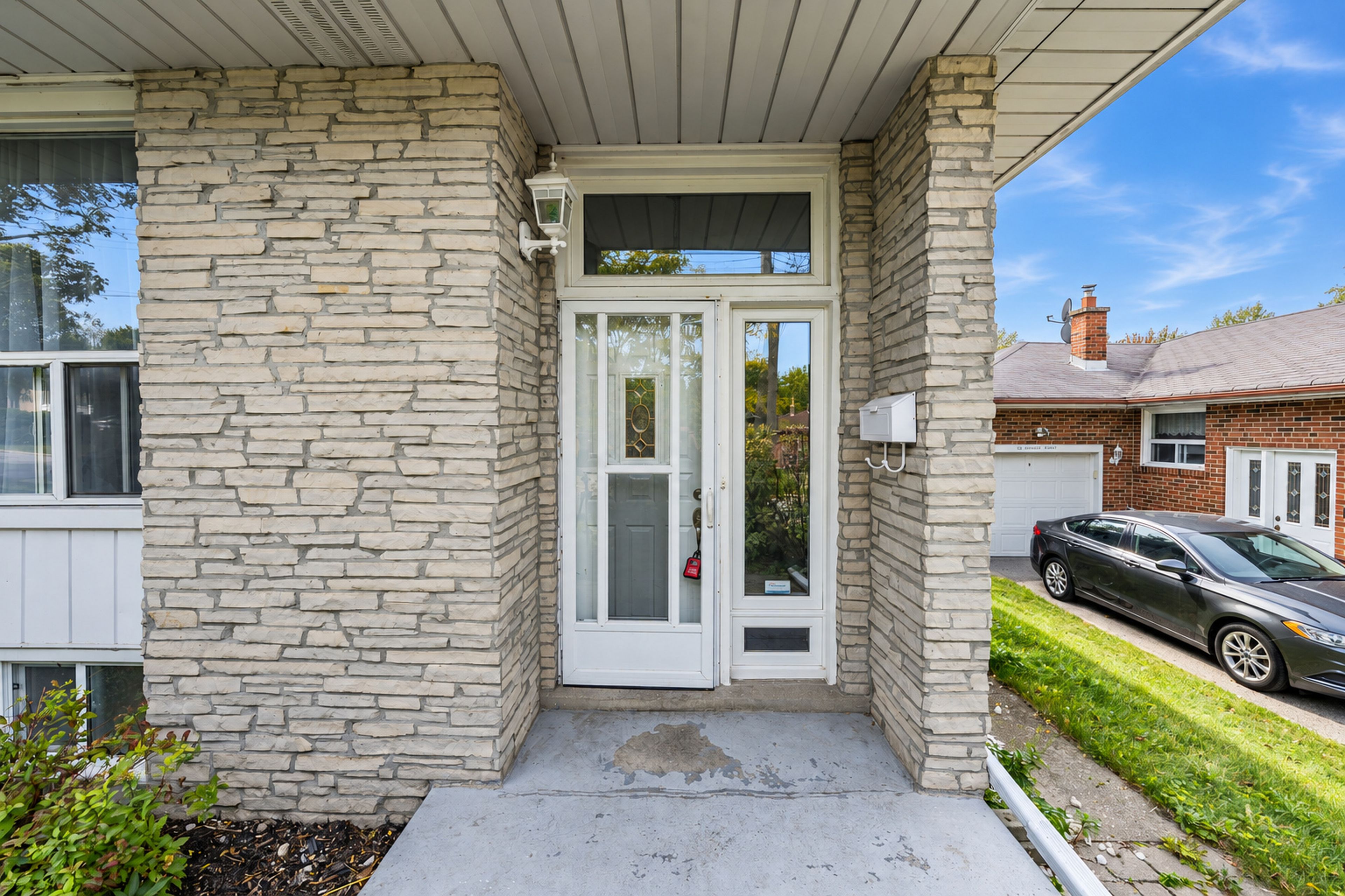 A house with a stone facade, a front door, and a garage.