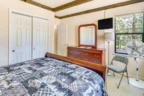 A bedroom with a bed, dresser, mirror, TV, and a chair. - 3-bedroom condo in fabulous Kings Beach close to Beach and Ski Resorts. (Kings Beach)