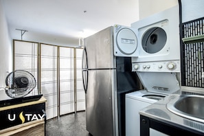 A compact kitchen with a refrigerator, washing machine, and a fan. - NO FEES! Downtown Studio-style L/O, Night Security (Mesa)