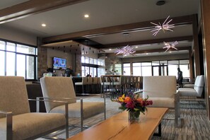 A spacious lobby with modern seating, a bar area, and large windows offering natural light. - Ski-in/out one-bedroom at Grand Colorado Peak 8, pools, spa, sleeps 4 (Breckenridge)