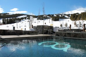 A swimming pool with a ski lift in the background. - Ski-in/out one-bedroom at Grand Colorado Peak 8, pools, spa, sleeps 4 (Breckenridge)