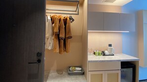 A modern bathroom with a towel rack, a sink with toiletries, and a shower area. - Ting Ran Yun Ju Hotel Guilin (Nanjing)