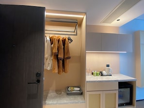 A modern bathroom with a towel rack, a sink with toiletries, and a shower area. - Ting Ran Yun Ju Hotel Guilin (Nanjing)