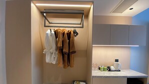 A modern bathroom with a towel rack, a countertop with toiletries, and a built-in shower area. - Ting Ran Yun Ju Hotel Guilin (Nanjing)