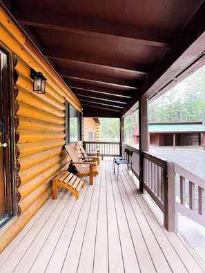 A wooden deck with benches and a railing, overlooking a gravel area. - Legacy Homestead Cabin, White Mountains AZ (Navajo County)