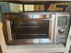 A Cuisinart oven with a digital display and control buttons. - Unique Treehouse - tiny home combo accommodation in the Ozarks under the stars! (Patterson)
