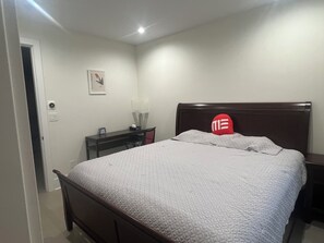 A bedroom with a bed, a desk, a chair, and a nightstand. - MEhome’s rental #1, best home short term rental (Richmond)