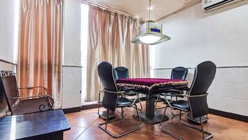 A conference room with a table, chairs, and a ceiling light fixture.