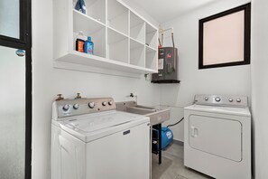 A laundry room with a washing machine, dryer, and a water heater. - Casa Jarrones Tulum- 3-bedroom condo w AC and gym-Pool/Gated/Near Beach/Cenotes (Tulum)