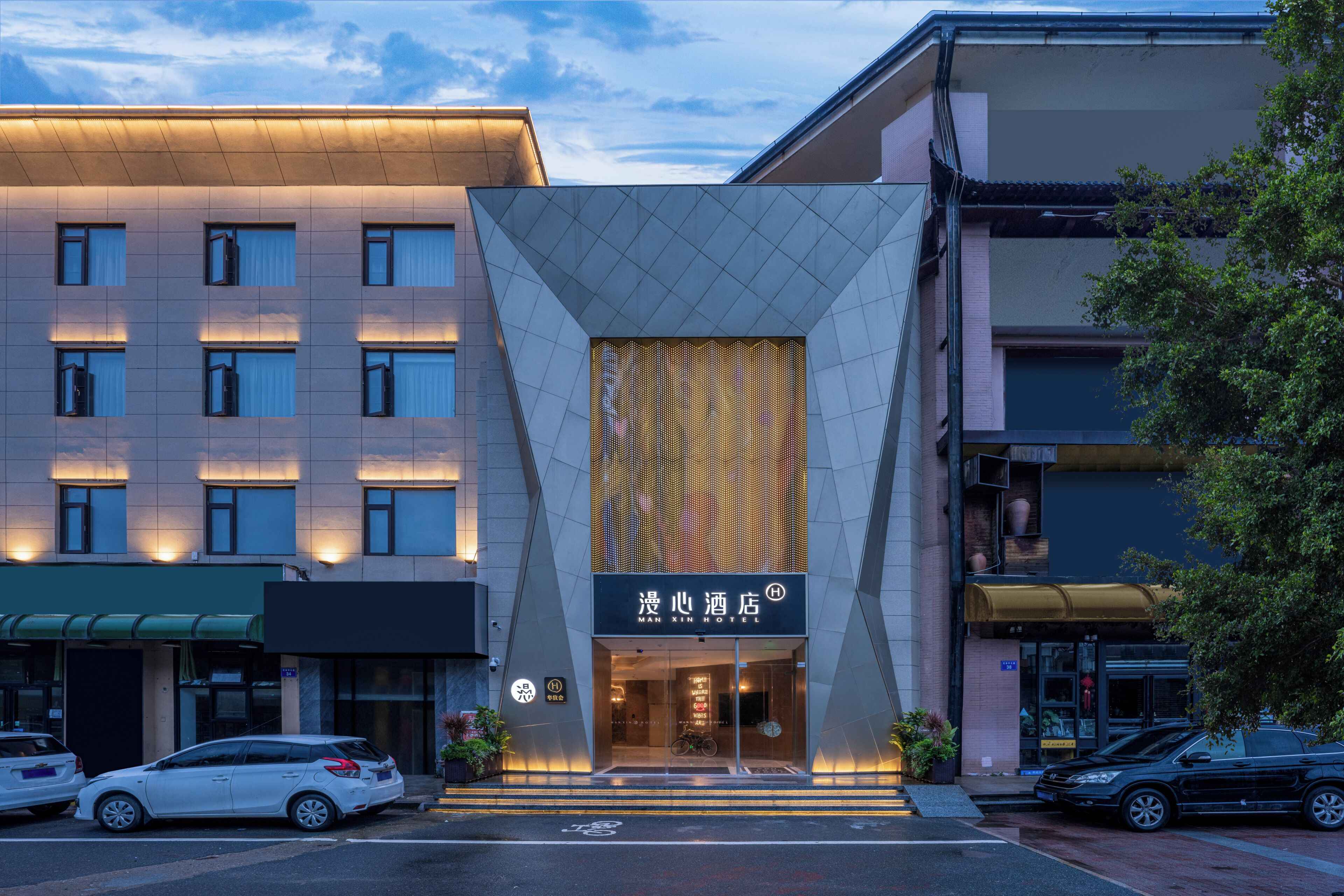 A hotel with a modern facade, a prominent entrance, and a visible sign with the hotel's name.