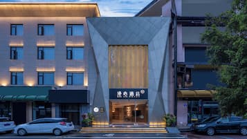A hotel with a modern facade, a prominent entrance, and a visible sign with the hotel's name.